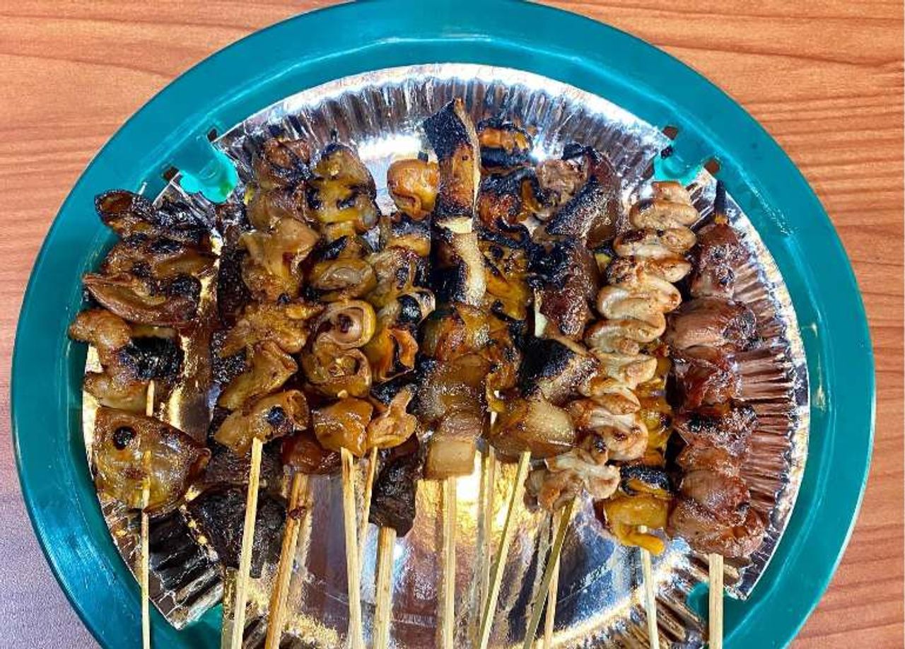 Mang Larry's isaw grilling over charcoal